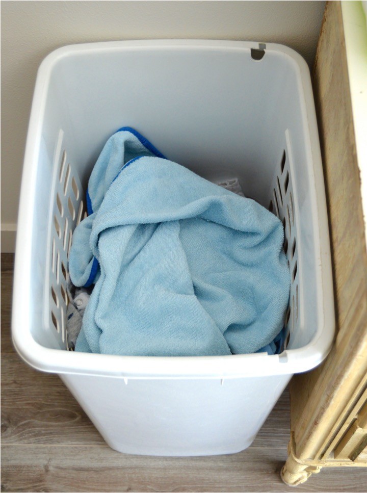 Baby's nursery laundry basket | Tips for how to make a practical diaper changing station. Changing table ideas like: repurpose a dresser, get a Diaper Genie, buy diapers and wipes in bulk, baby changing pad + more ideas for your baby's nursery. DIY dresser changing table hack. Tips and tricks for when baby comes like where to go shopping for a diaper pail.