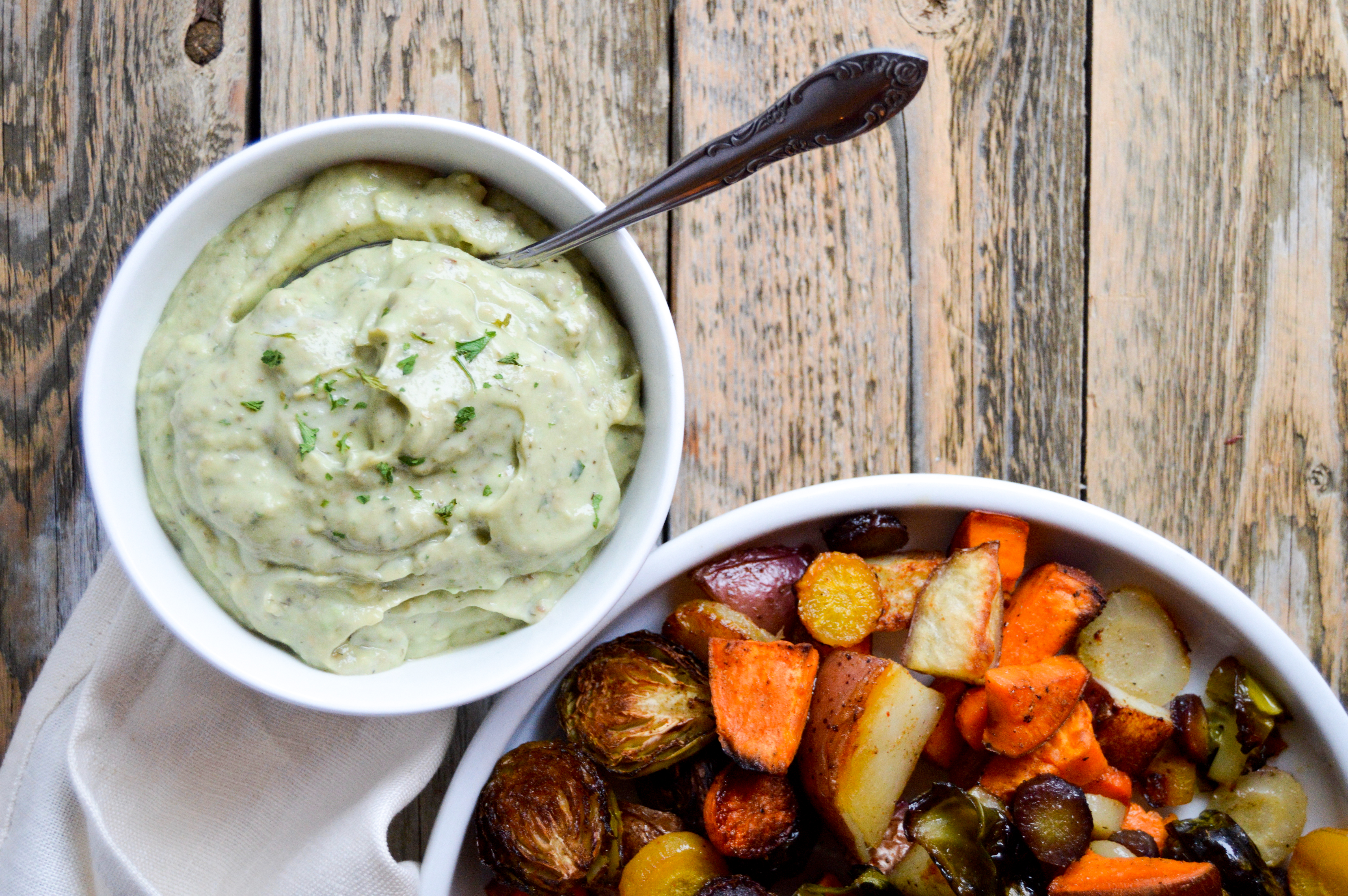 Recipe for baking hearty sheet pan veggies and avocado ranch dip recipe. Vegetable filled dinner idea for a healthy meal. Corn oil and avocado substitutions. Rainbow carrots, brussels sprouts, sweet potato, and red potato veggies baked with corn oil and seasonings. Delicious, easy, healthy dinner dish.