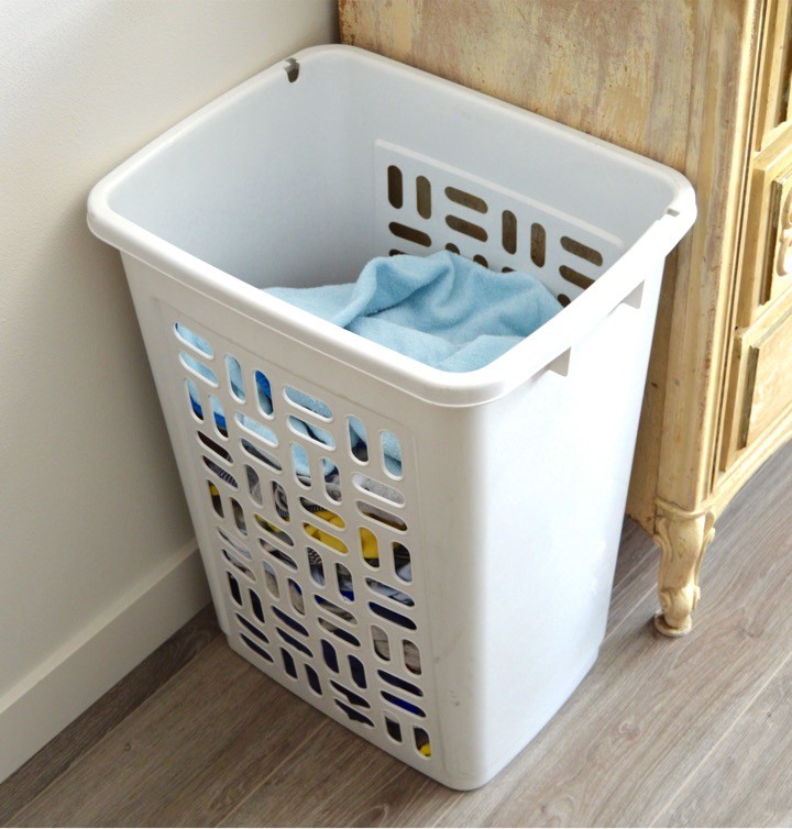 Laundry basket by the changing table | Tips for how to make a practical diaper changing station. Changing table ideas like: repurpose a dresser, get a Diaper Genie, buy diapers and wipes in bulk, baby changing pad + more ideas for your baby's nursery. DIY dresser changing table hack. Tips and tricks for when baby comes like where to go shopping for a diaper pail.