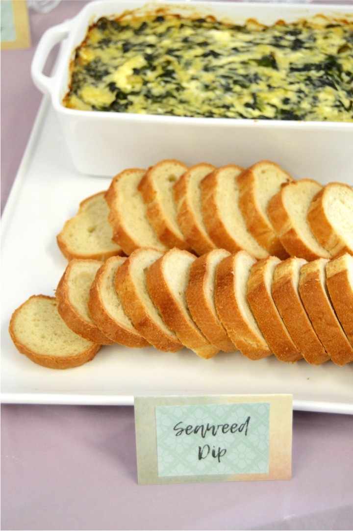 Seaweed Dip is spinach artichoke dip with bread. Themed nautical food. Sailing baby shower inspiration with a nautical theme. Food, party decorations, invitation, games, + gift ideas for an adventure sailing girl's baby shower.