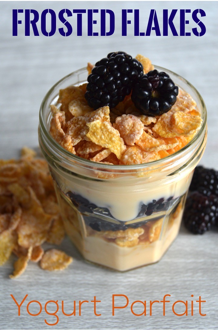 FROSTED FLAKES CEREAL YOGURT PARFAIT with peach yogurt and blackberries | Cute Tony the Tiger colors | Breakfast recipe for a cereal yogurt parfait with fruit. Ideas for Kellogg cereal parfait: Apple Jacks, Froot Loops, and Frosted Flakes. Fun breakfast idea!