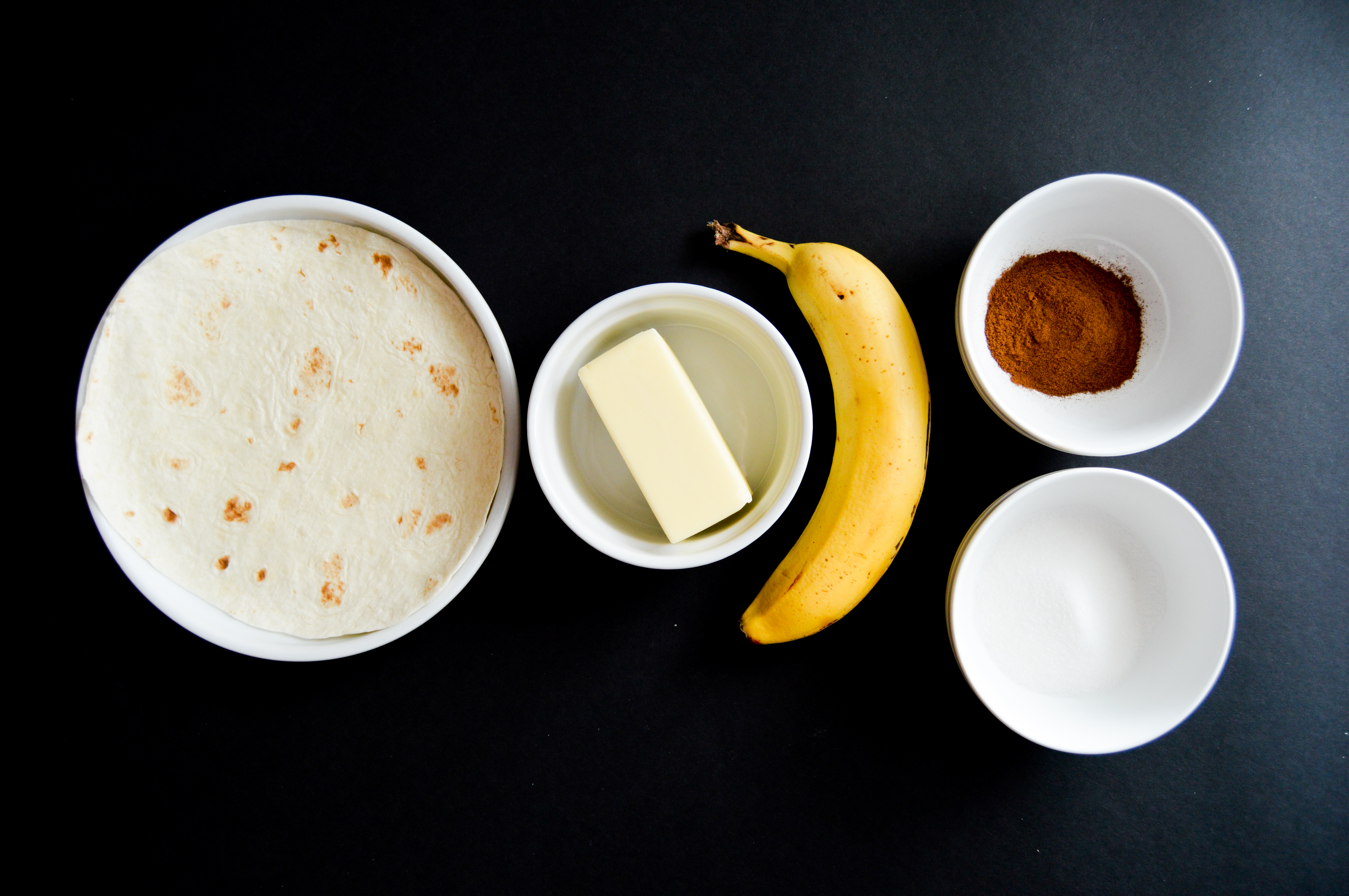 Ingredients for banana cinnamon sugar tortilla roll ups