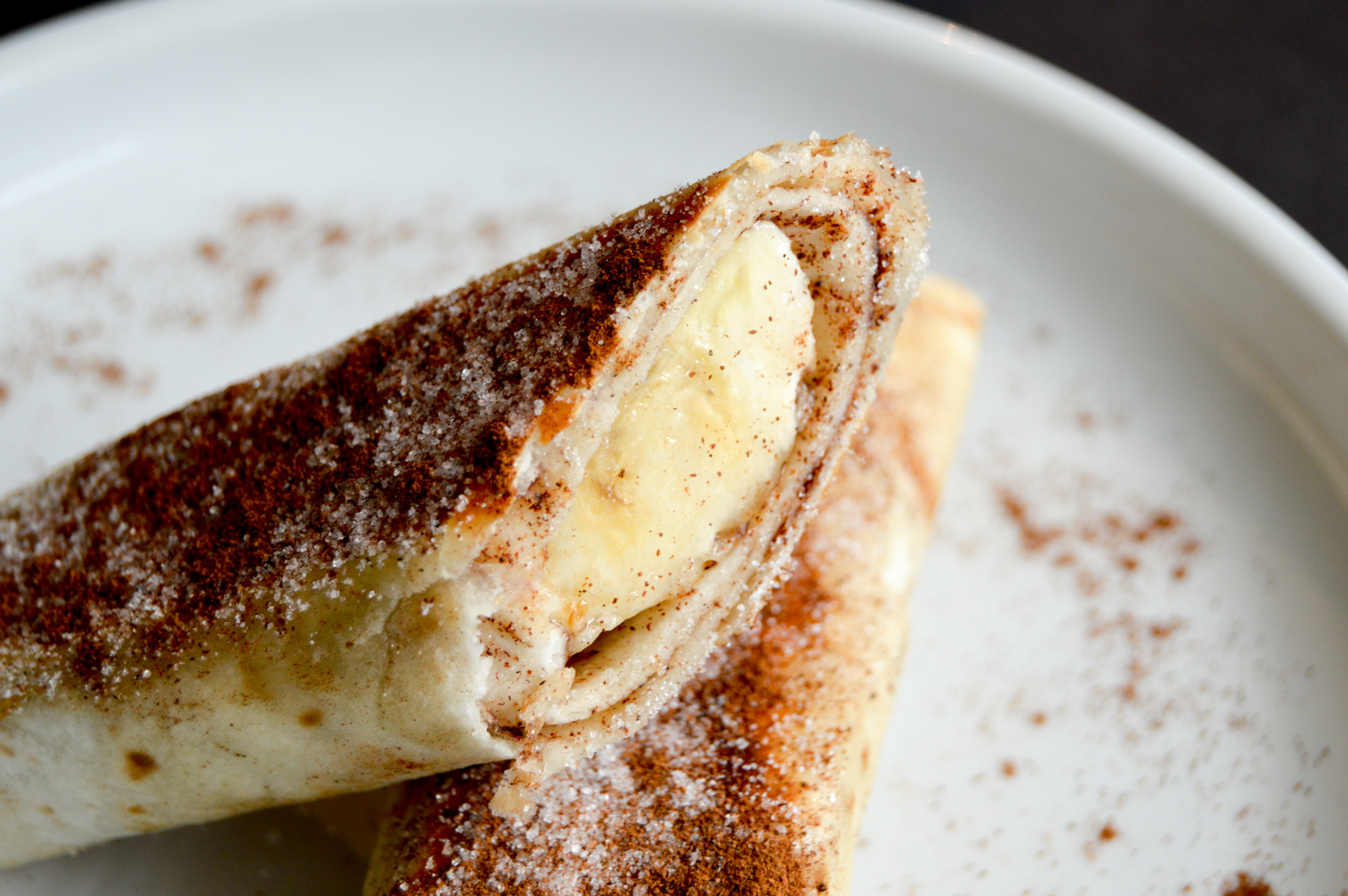 Banana cinnamon sugar tortilla roll ups recipe inspired by churros. These easy banana churro pinwheels make a tasty snack, appetizer, or treat for Cinco de Mayo. Simple 5 ingredient recipe that the kids will love! 