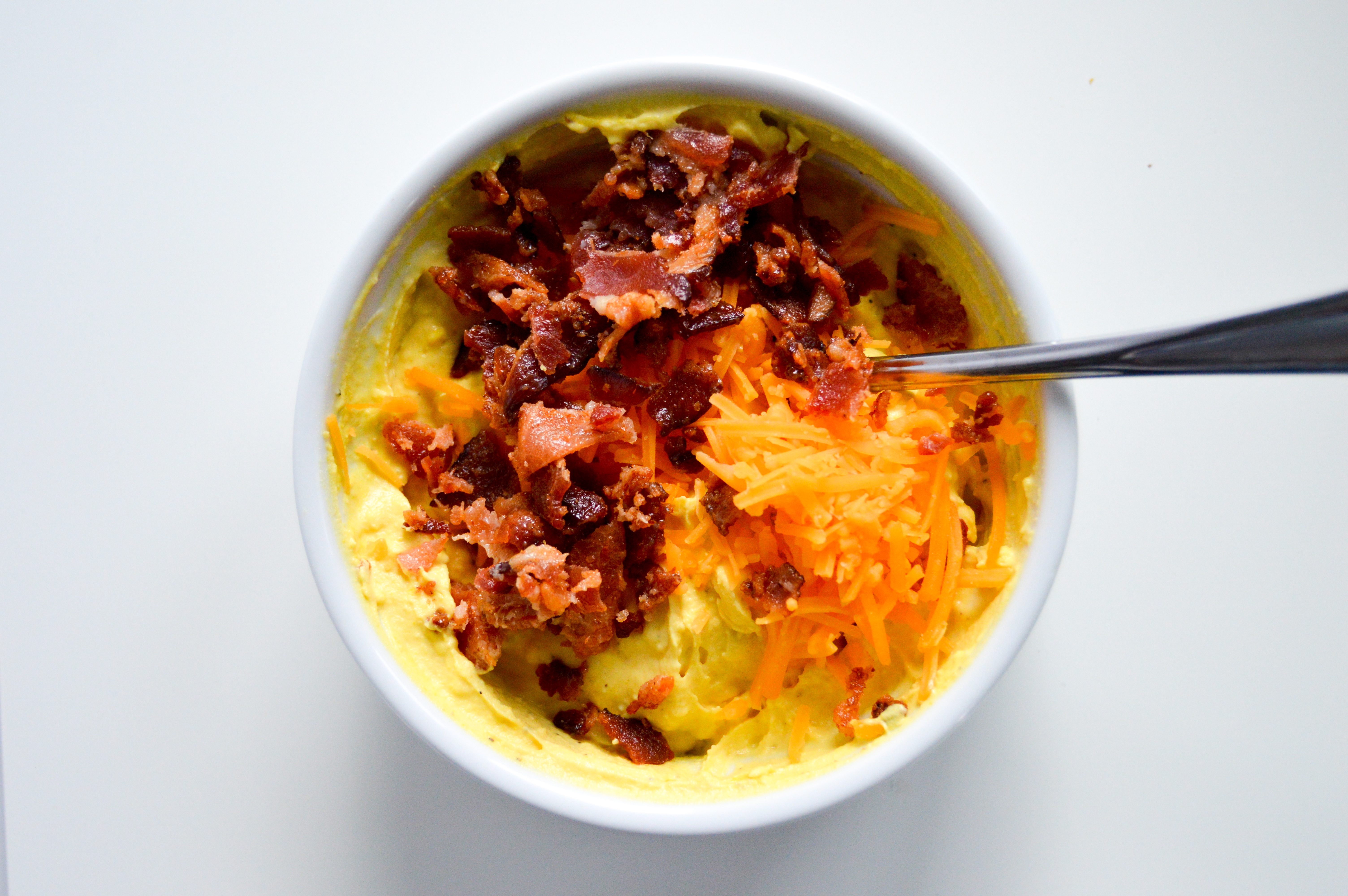 Directions for Bacon Loaded Deviled Eggs - create yolk mixture. Add shredded cheddar cheese and bacon crumbles