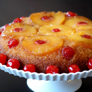 Pineapple is king. I mean, it literally has a crown. So if you're in the mood for a royal dessert, this Pineapple Upside-Down Cake recipe with fun pops of color and bursts of flavor is fit to rule! Snag the recipe below. Pineapple Upside-Down Cake Recipe Ingredients & Directions Ingredients 1/3 cup butter 3/4 cup packed brown sugar 12 slices of pineapple, drained, juice reserved 1 jar (6 oz) maraschino cherries without stems, drained 1 box yellow cake mix (including oil and eggs called for on cake mix box) Directions Heat oven to 350 degrees F. In a 13x9-inch pan, melt the butter in the oven. Carefully and safely remove the pan from oven. Sprinkle the brown sugar across the bottom of pan. Stir and spread the butter and brown sugar mixture evenly in the pan. Arrange pineapple slices evenly on top of the brown sugar. Place a cherry in the center of each pineapple slice, and arrange the remaining cherries around the slices. Press each cherry gently into the brown sugar. Add enough water to the reserved pineapple juice to measure 1 cup. Make the cake batter as directed on the box, substituting the pineapple juice mixture for the water. Pour the batter over the pineapple and cherries. Bake for ~45 minutes or until toothpick inserted in the center comes out clean. Carefully and safely remove the pan from oven. Immediately run a knife around the side of the pan to loosen the cake. Place a heatproof serving plate upside-down onto the pan, and turn the plate and pan over. Leave the pan over the cake for 5 minutes so the brown sugar topping can drizzle over the cake. Remove the pan. Let the cake cool for 30 minutes. Serve warm or cool. Store covered in the refrigerator.
