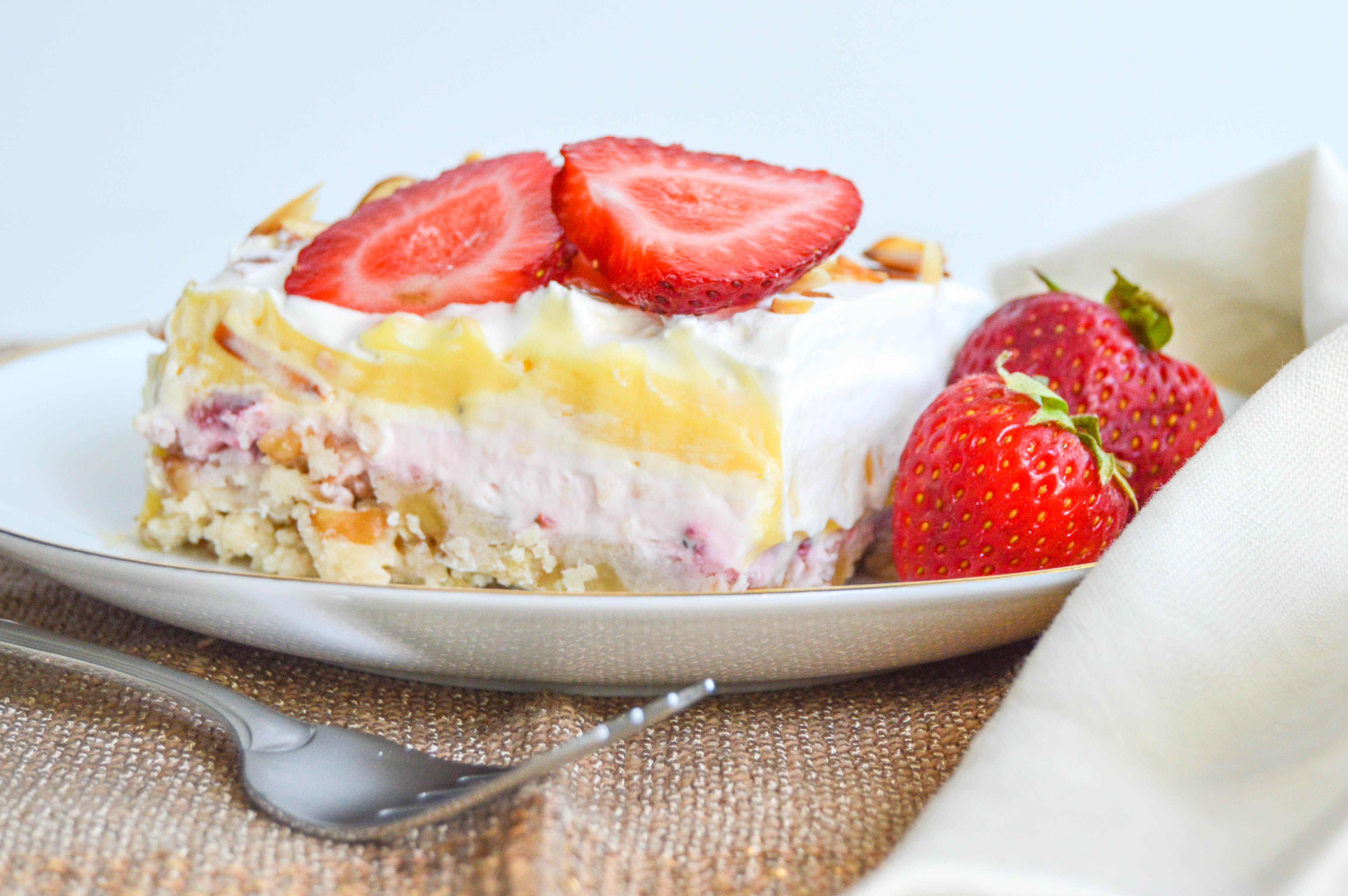 Strawberry vanilla lush is a crust, cream cheese cheesecake, pudding, and whipped cream layered dessert. This 9x13 pan chilled treat recipe is perfect for a big group.