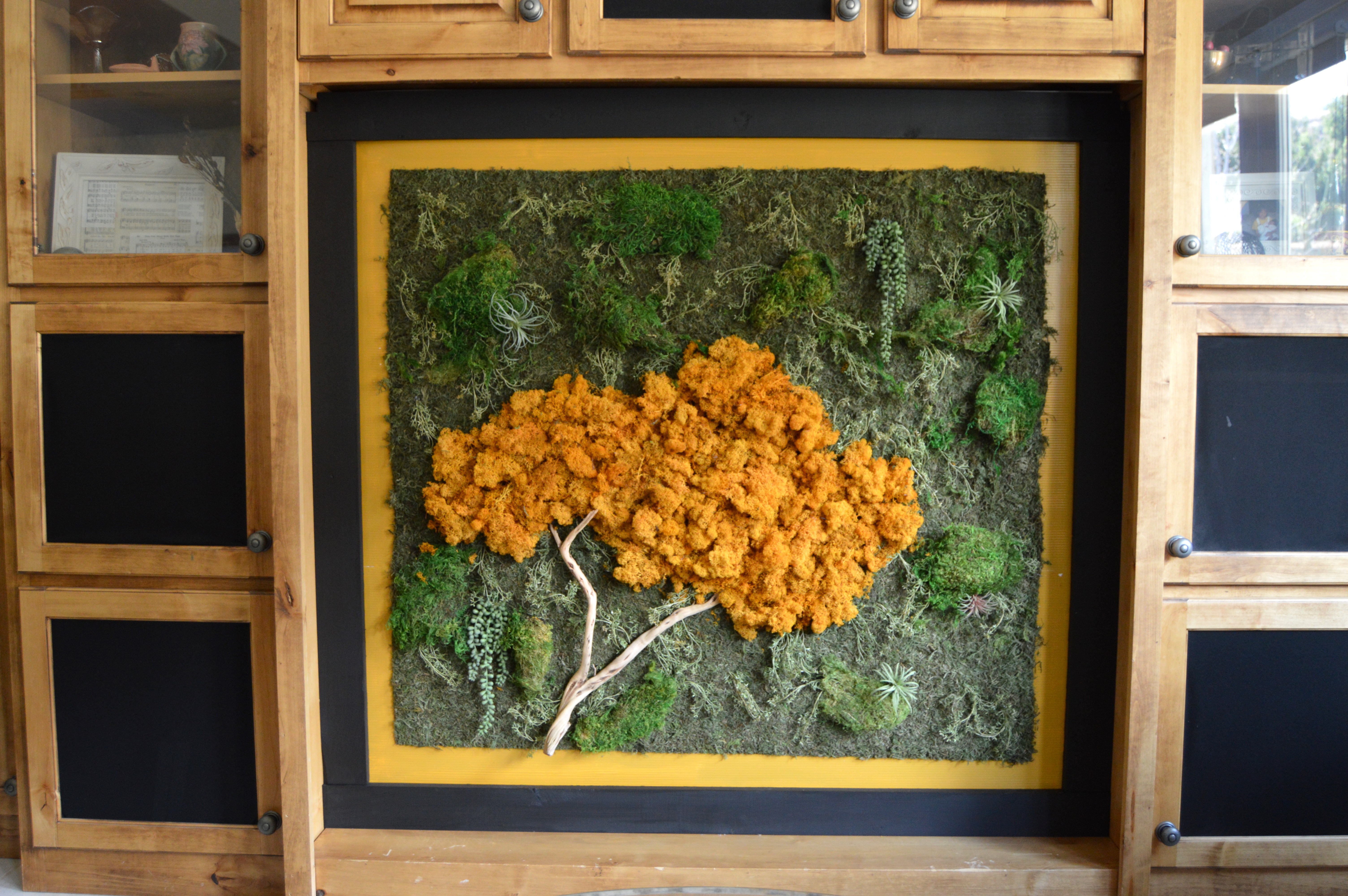 The after: Yellow moss tree in black and gold frame. How to make a DIY moss wall art statement piece. How I turned my mom's entertainment center hole into a (preserved) living wall.