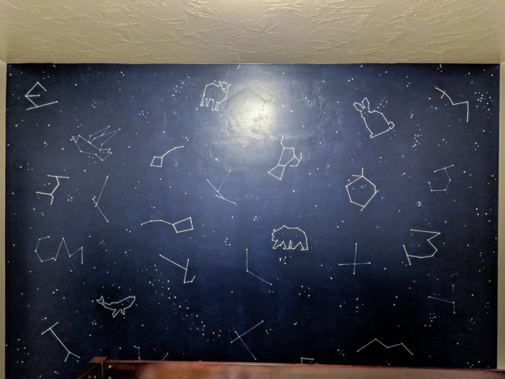 DIY Constellation Wall - Constellation mural wall DIY project and tutorial for painting one in your nursery or kids bedroom. Our star and space themed kids bedroom with constellations, stars, astronauts, planets, and counting sheep corner. Two kids in a shared bedroom with a low loft bed and a crib. Neutral decor for both genders, boy and girl.