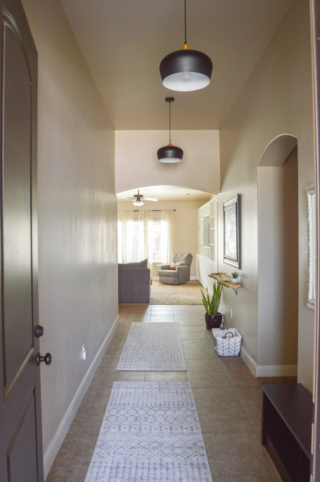 Modern, boho hallway and long entryway ideas. Our entry hallway makeover including pendant lighting, coat hangers, live edge shelf. Before hanging our travel gallery.