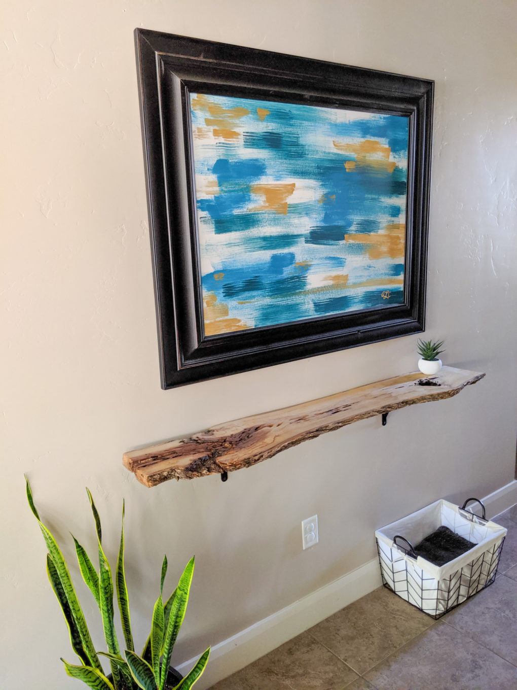 Finished product. How to make a DIY live edge wood shelf from a wood slab. The sanding, protective coat, and brackets  used to secure it. Great hallway shelf or console table.