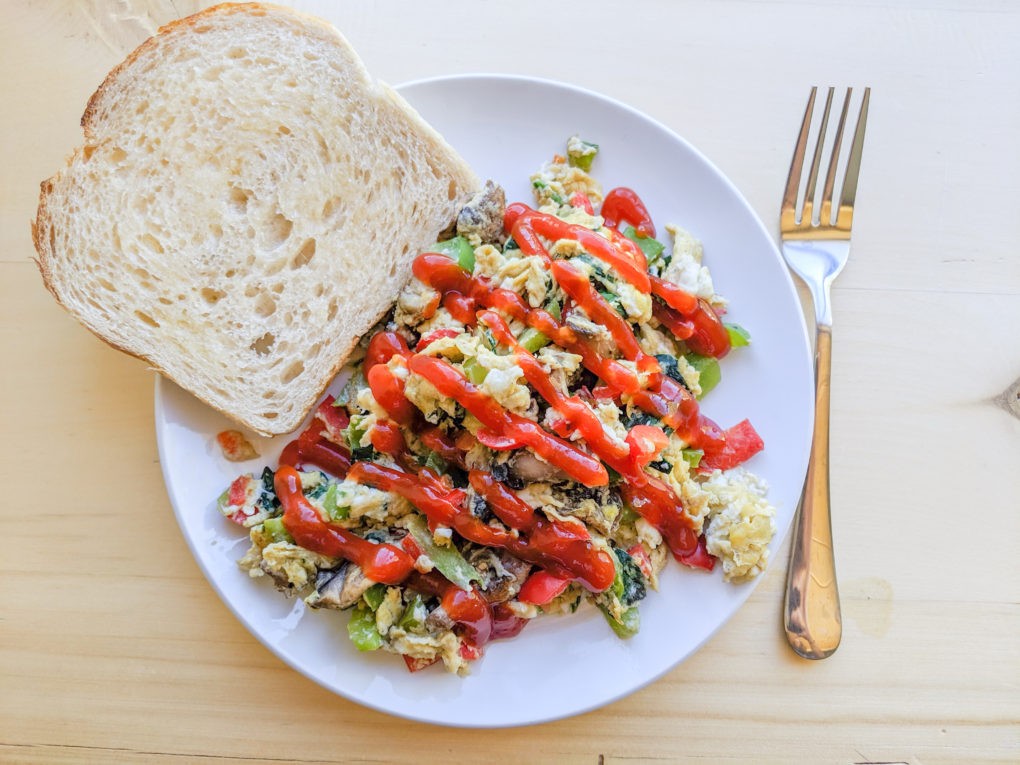 Veggie scrambled eggs with toast for our women's wellness retreat on a budget. Girl's trip healthy meal ideas and menu plan.