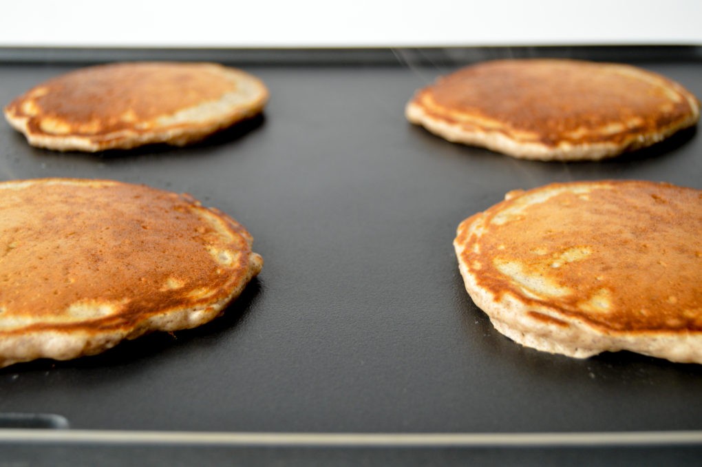 Golden brown cinnamon pancakes on the griddle